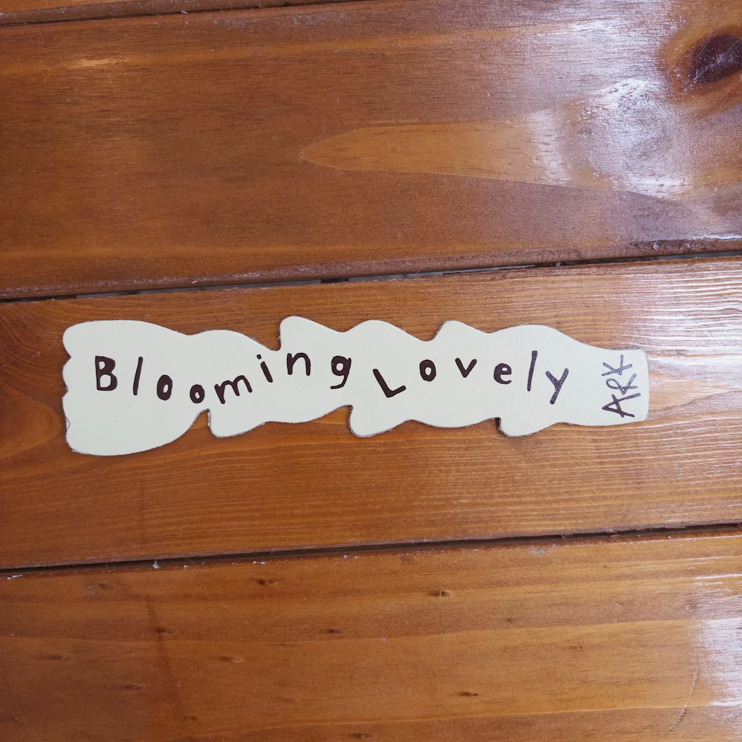 Tulip shaped bookmark that has text that reads blooming lovely