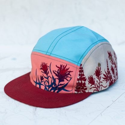 Colorful cap with floral design on a light blue background