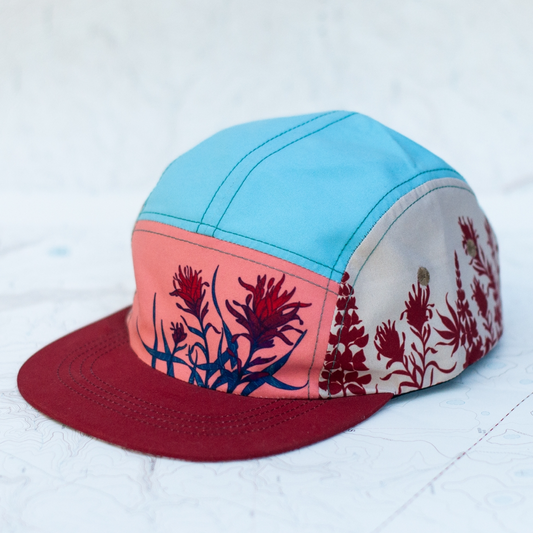 Colorful cap with floral design on a light blue background