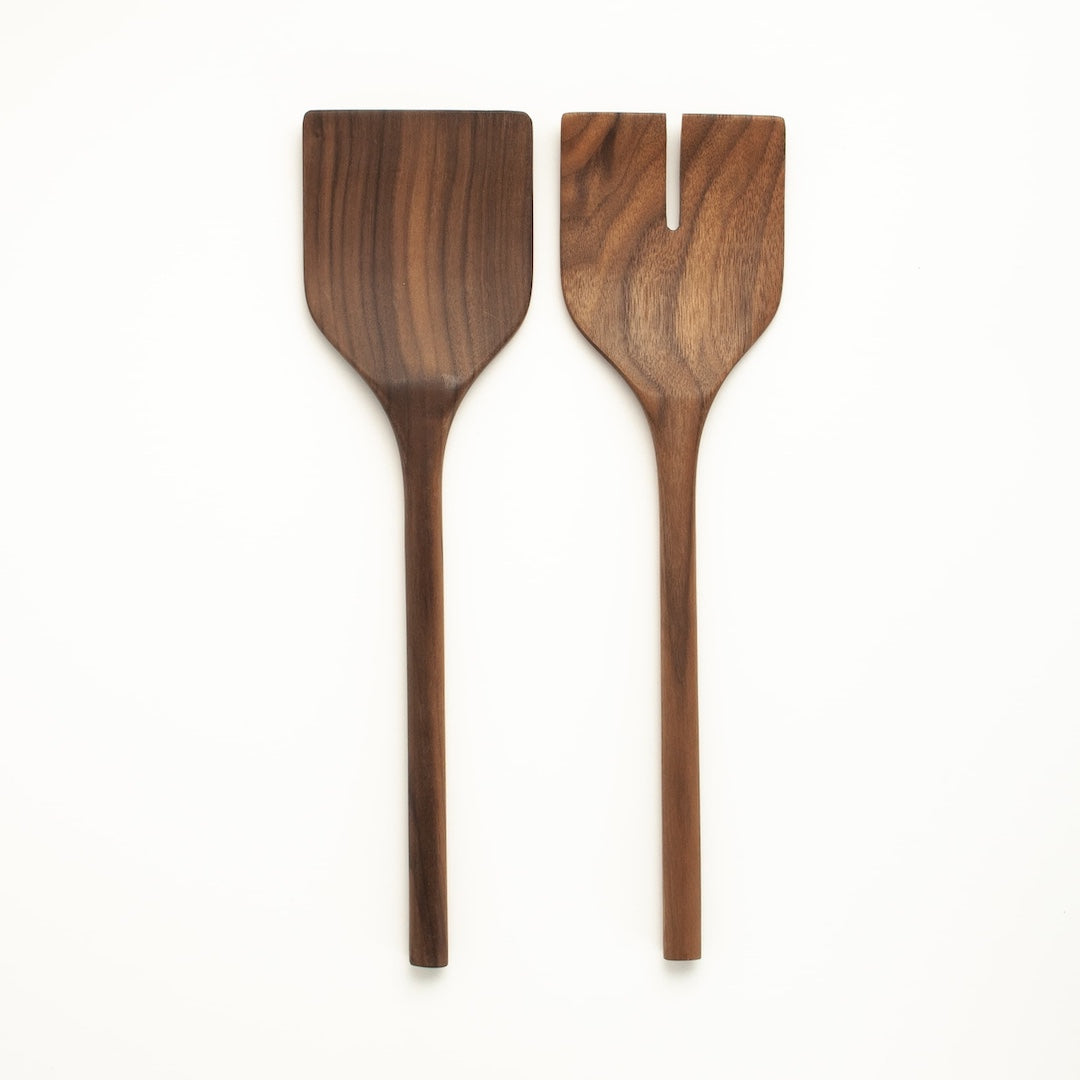 Set of wooden salad servers on a white background