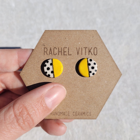 Yellow and polka dot ceramic studs on Rachel vitko branded backing