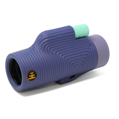 A monocular with a textured purple body, a light purple eyecup, and a mint green textured focus knob, shown on a white background.